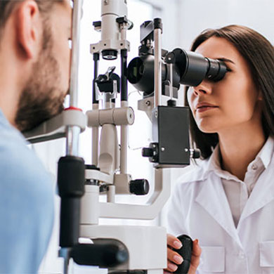 woman eye doctor giving patient exam