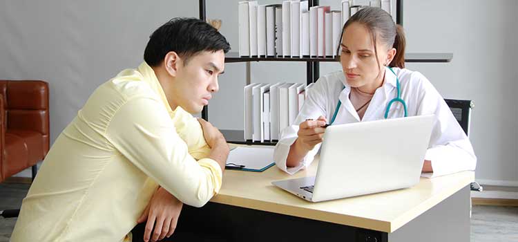 woman showing mad dental assistant program options on laptop