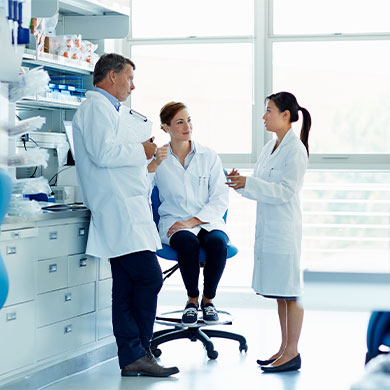 lab coat technicians meet in medical facility