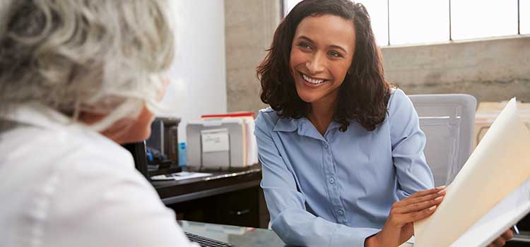 office worker discussing certification with administrator